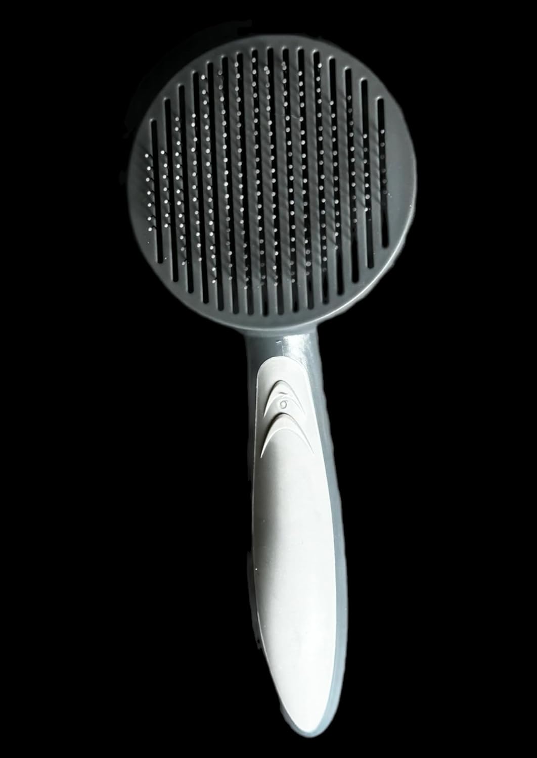 De-shedding dog brush showing rubber handle, stainless steel needles and ergonomic handle